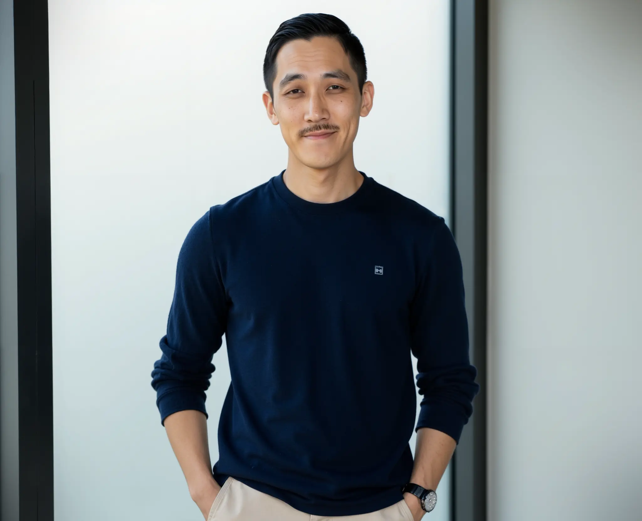 Chiwoo standing in a dark blue shirt with his hands in his pockets